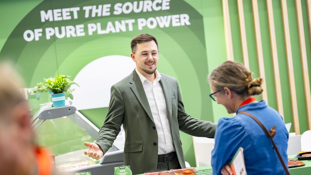 Exhibition stand at Anuga Alternatives with visitors sampling the plant-based burgers and other protein innovations.