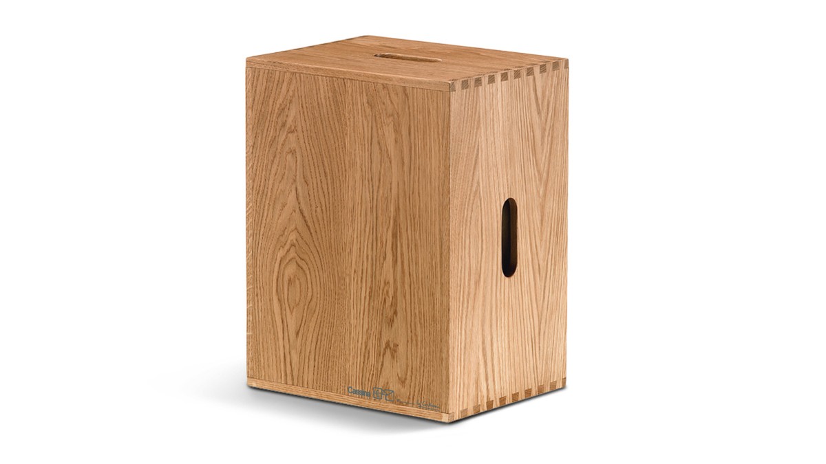 Simple, cube-shaped wooden stool with handle slot.