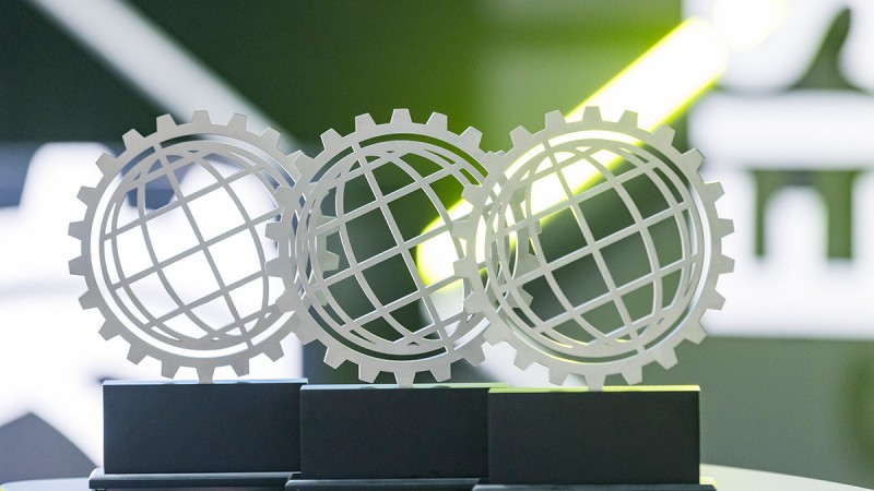 Three trophies with stylised silver globe on black base