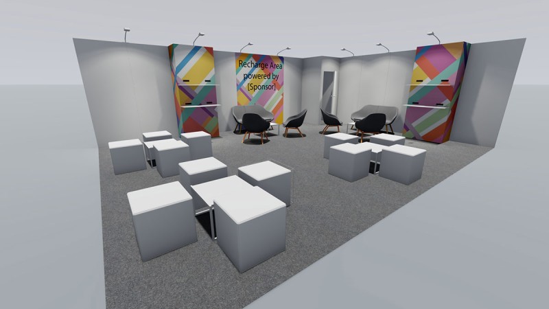 Lounge area with white cube stools and black armchairs, signposted as “Recharge Area” with colourful geometric patterns