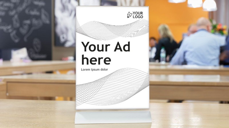 Table display with exemplary advertising space, people can be seen in the background