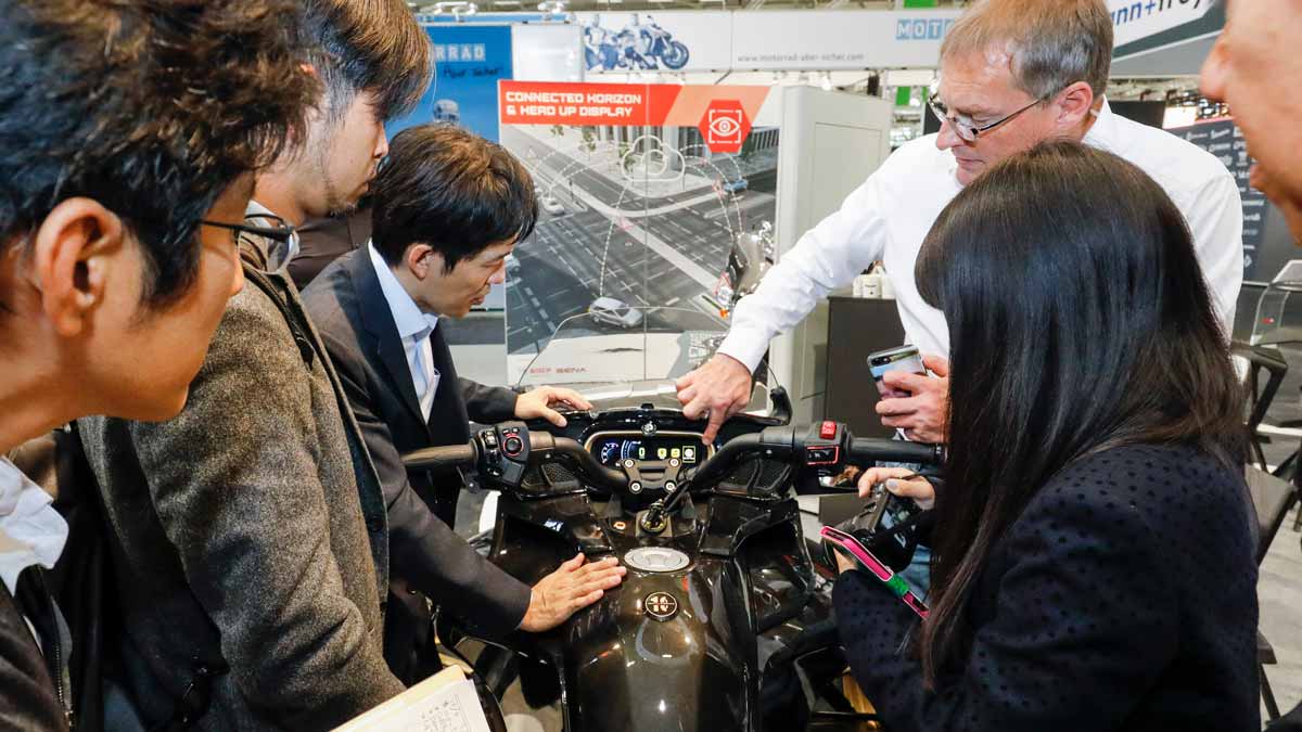 People in front of a motorcycle