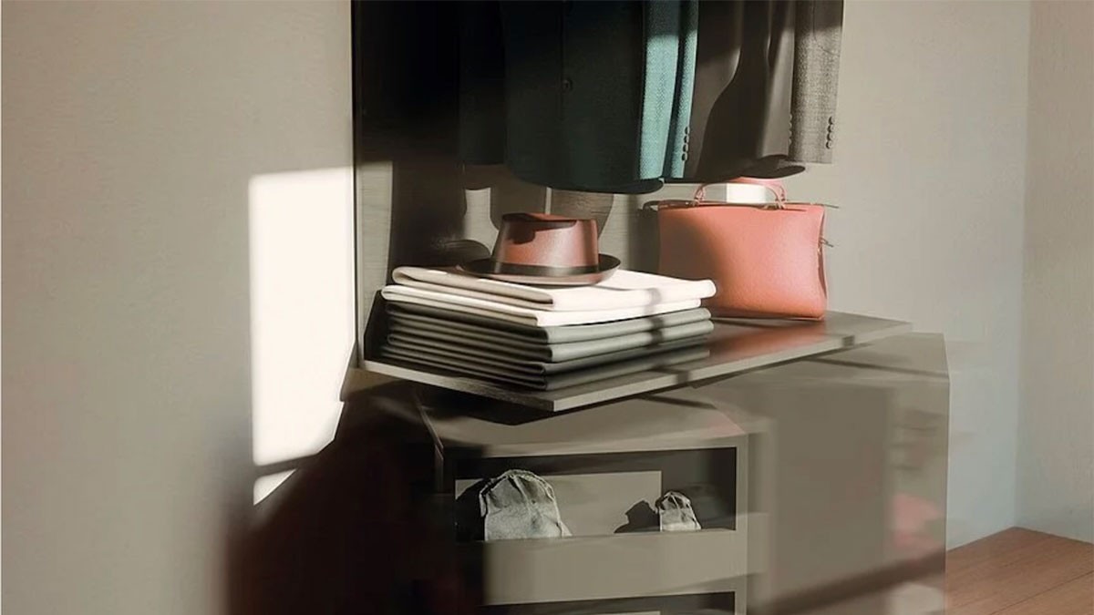 Clothes and accessories displayed on a shelf in a minimalist interior.