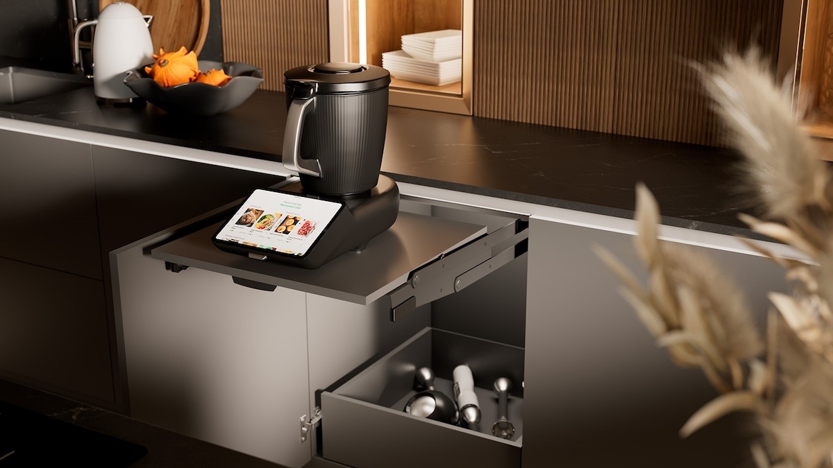 A pull-out table in the base cabinet with a mixer featuring a large digital display