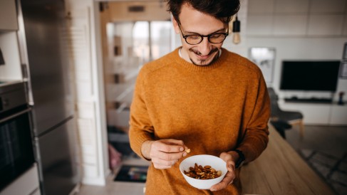 Man eating a bowl of mixed nuts_1200x675
