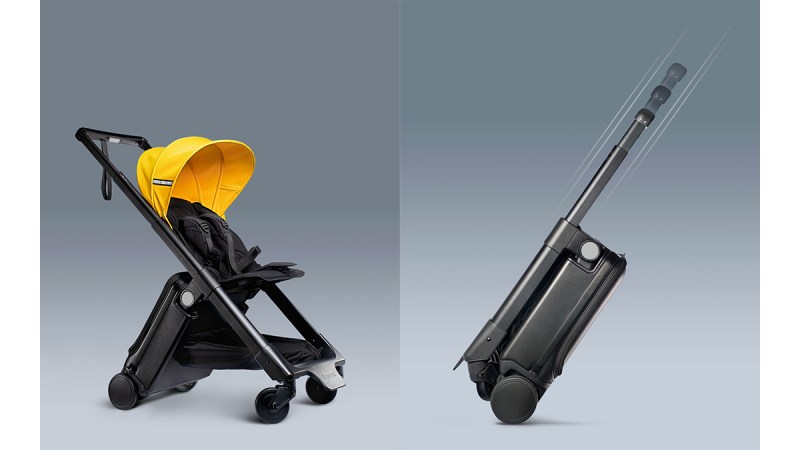 Black and yellow TernX stroller folded into compact suitcase shape with extended handle for easy transport