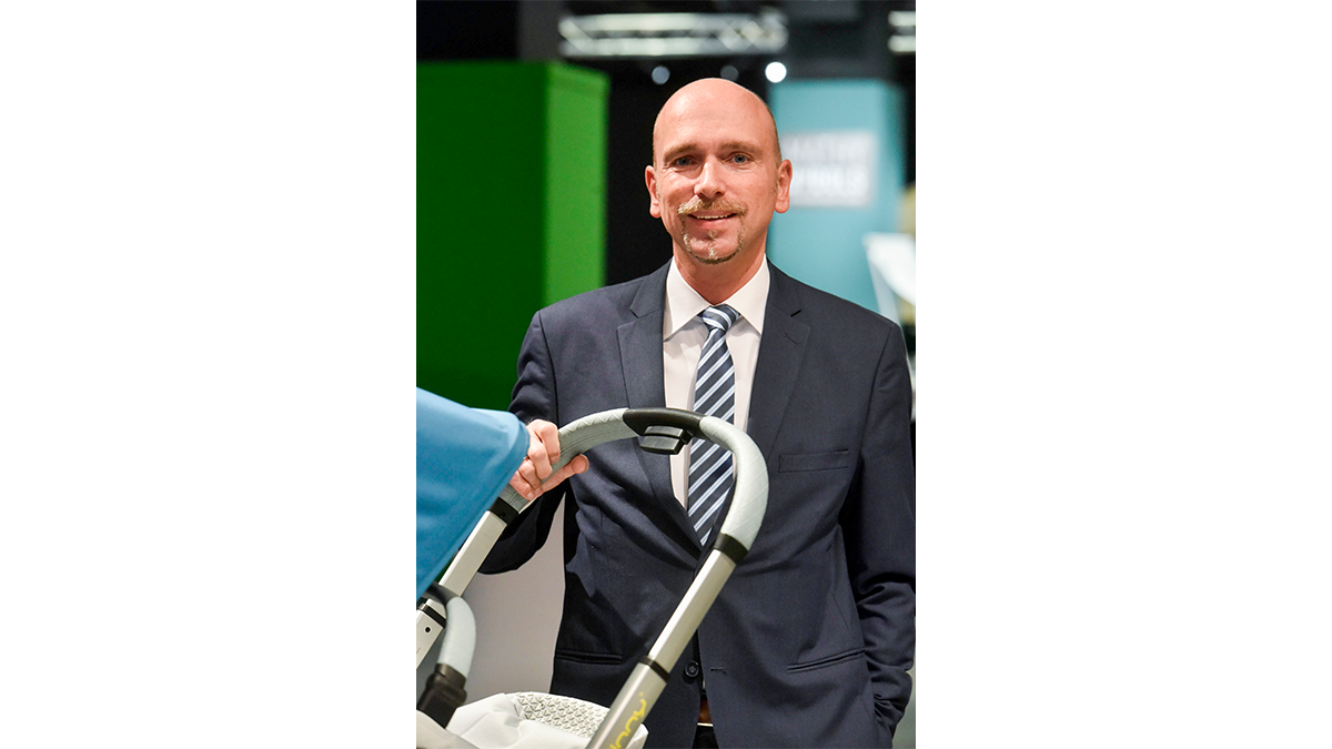 Joerg Schmale pushes a pram on the fair grounds