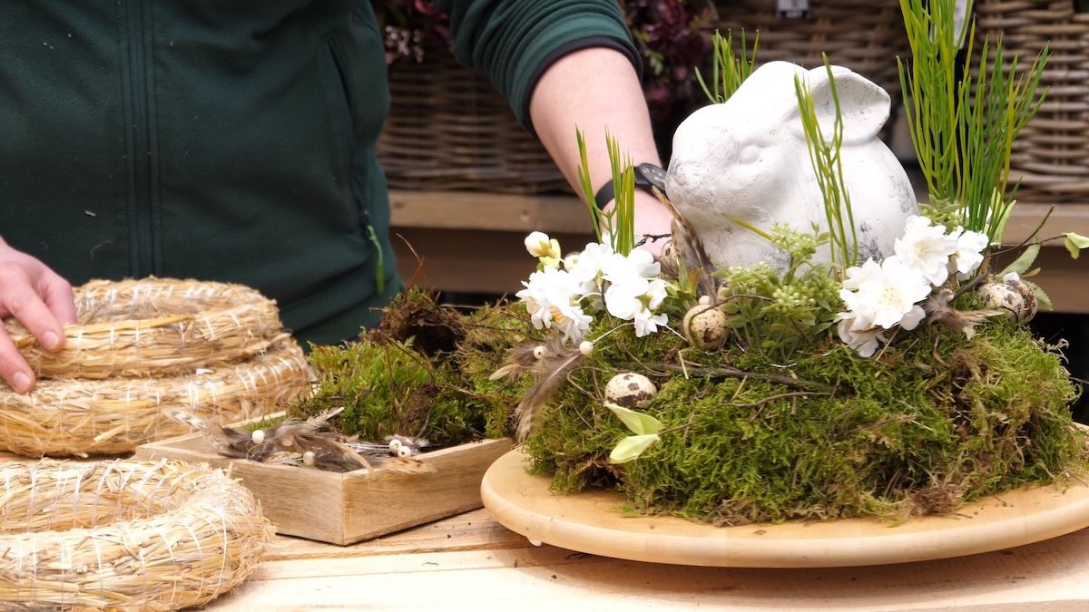 Easter arrangement with moss, flowers, and bunny